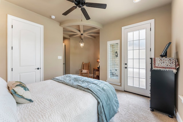 bedroom featuring beam ceiling, access to outside, recessed lighting, light colored carpet, and arched walkways