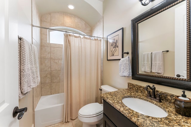 bathroom with toilet, shower / bath combo with shower curtain, and vanity