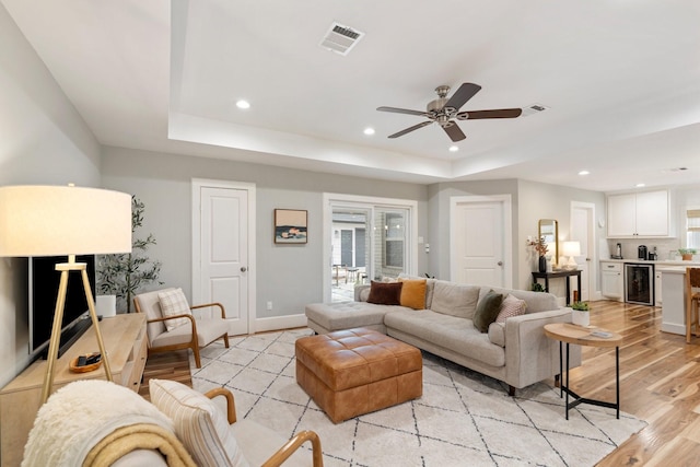 living room with visible vents, recessed lighting, light wood finished floors, and beverage cooler