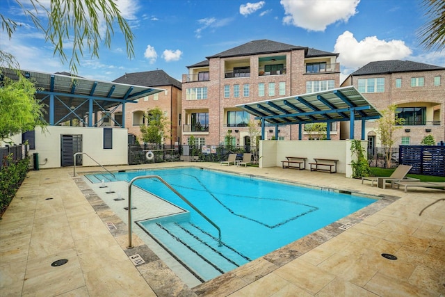 community pool with fence and a pergola