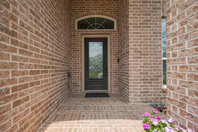 entrance to property with brick siding