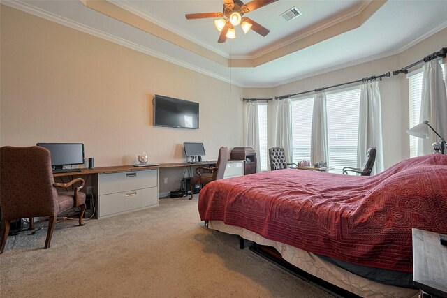 bedroom with visible vents, ornamental molding, light carpet, ceiling fan, and a raised ceiling
