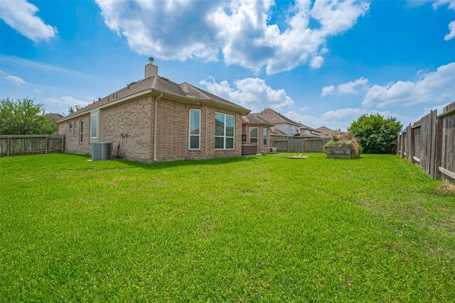 view of yard featuring central AC unit and a fenced backyard