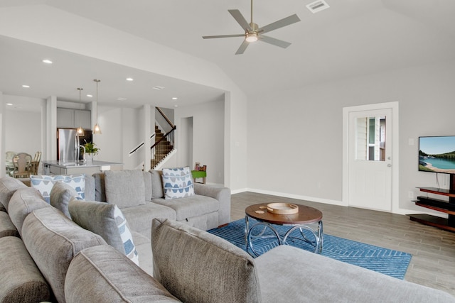 18331 Yaupon Bough Ln, Tomball, TX 77377 - living room featuring stairs, visible vents, wood finished floors, and vaulted ceiling