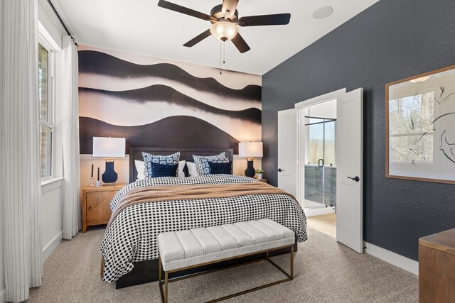 carpeted bedroom with baseboards, connected bathroom, a textured wall, and a ceiling fan