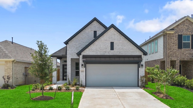 21517 Witham Promenade Ln, Magnolia, TX 77355 - view of front of home with a front yard, concrete driveway, brick siding, and a garage