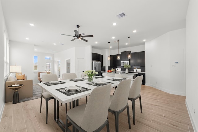 21517 Witham Promenade Ln, Magnolia, TX 77355 - dining room with light wood-type flooring, a ceiling fan, baseboards, and recessed lighting