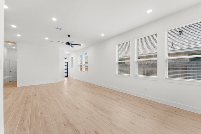 21517 Witham Promenade Ln, Magnolia, TX 77355 - unfurnished living room featuring light wood-type flooring, recessed lighting, ceiling fan, and baseboards