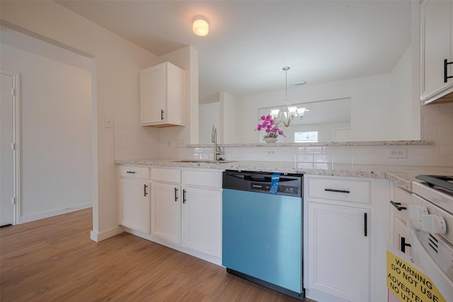 kitchen with a sink, dishwashing machine, light wood-style flooring, and tasteful backsplash