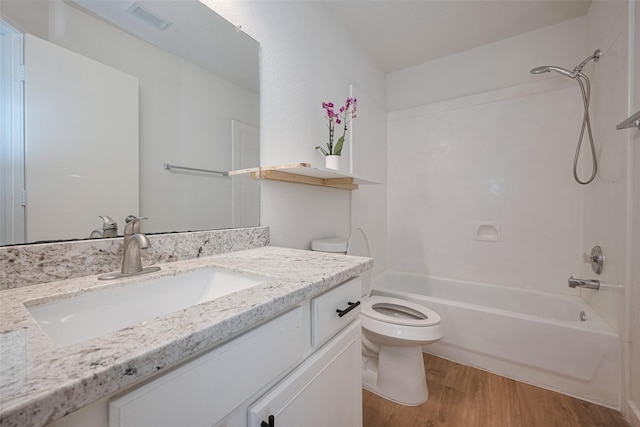 full bathroom with vanity, toilet, shower / bath combination, wood finished floors, and visible vents
