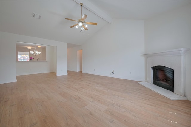 unfurnished living room featuring a fireplace with raised hearth, beamed ceiling, visible vents, and light wood-style floors