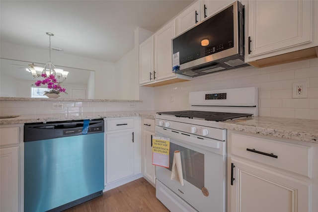 10918 Linden Gate Dr, Houston, TX 77075 - kitchen with white gas range, tasteful backsplash, stainless steel microwave, and dishwasher