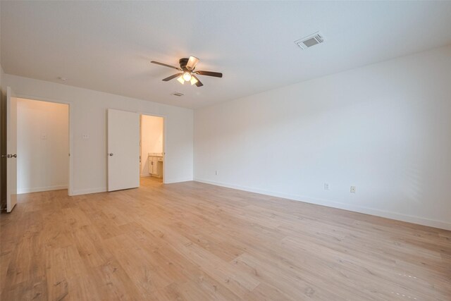 unfurnished bedroom featuring a ceiling fan, baseboards, visible vents, and light wood-style floors
