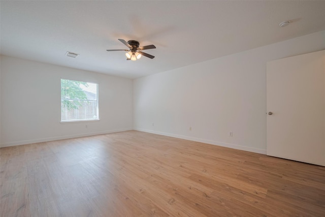 unfurnished room featuring visible vents, light wood finished floors, ceiling fan, and baseboards