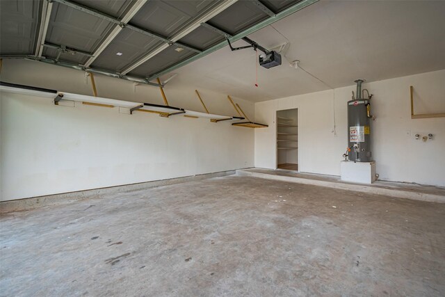 garage with water heater and a garage door opener