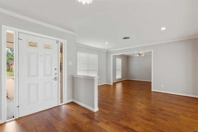 entryway featuring crown molding, wood finished floors, baseboards, recessed lighting, and a notable chandelier
