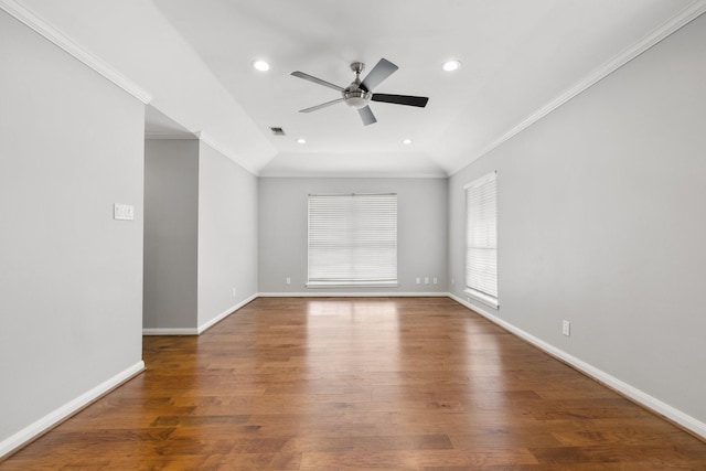 spare room with a ceiling fan, baseboards, wood finished floors, lofted ceiling, and ornamental molding