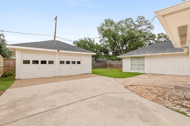 detached garage featuring fence