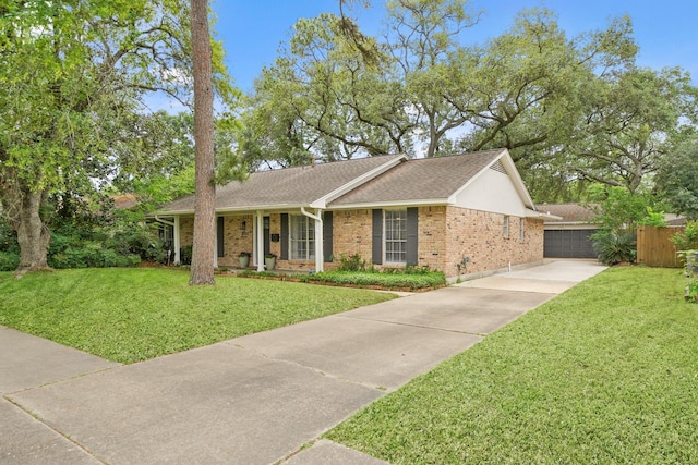 single story home with covered porch, a shingled roof, a front lawn, and brick siding