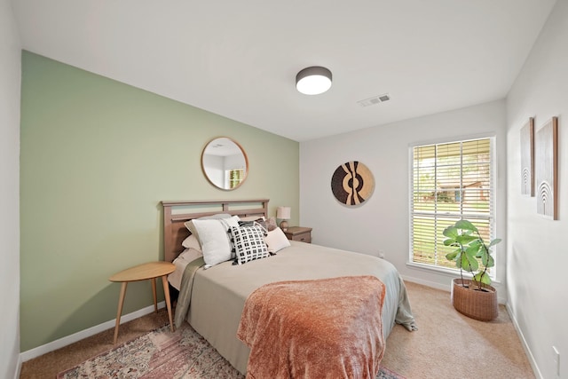 carpeted bedroom with baseboards and visible vents