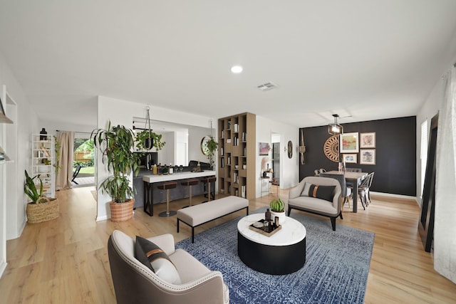 living area featuring visible vents and light wood-type flooring