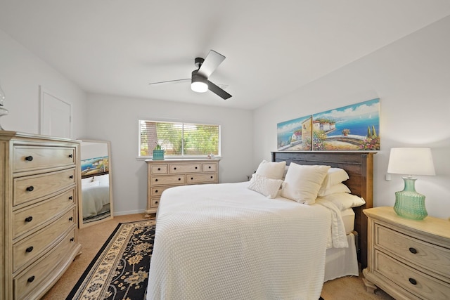 bedroom featuring light carpet and a ceiling fan