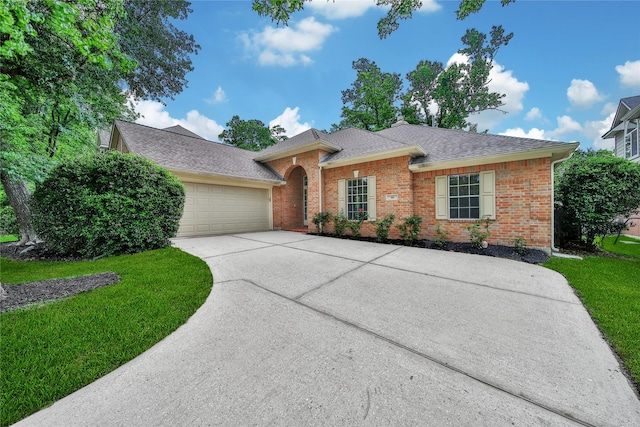ranch-style home featuring driveway, a front yard, a garage, brick siding, and a shingled roof