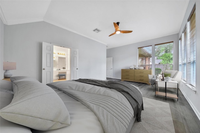 bedroom featuring visible vents, ornamental molding, lofted ceiling, wood finished floors, and baseboards