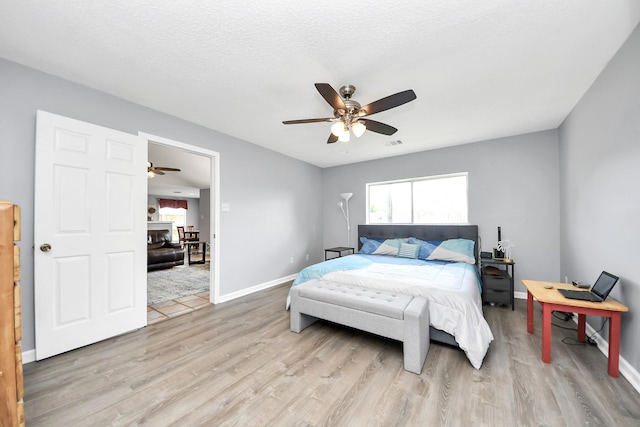 6102 Ghana Ln, Pasadena, TX 77505 - bedroom with light wood-style flooring, ceiling fan, and baseboards