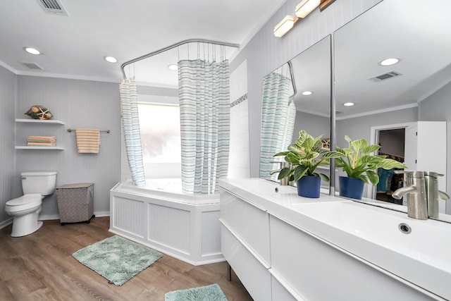 6102 Ghana Ln, Pasadena, TX 77505 - bathroom with toilet, wood finished floors, crown molding, recessed lighting, and double vanity