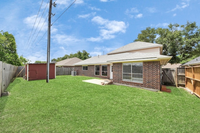 6102 Ghana Ln, Pasadena, TX 77505 - rear view of house featuring a storage unit, brick siding, an outbuilding, a patio area, and roof with shingles