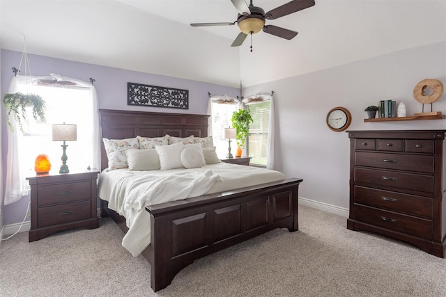 bedroom featuring baseboards, a ceiling fan, vaulted ceiling, and light carpet
