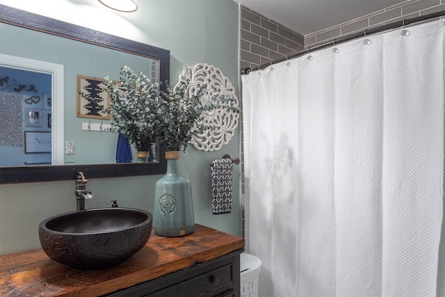 full bath featuring vanity and curtained shower