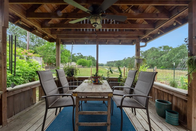 sunroom / solarium with ceiling fan, a wealth of natural light, and outdoor dining space