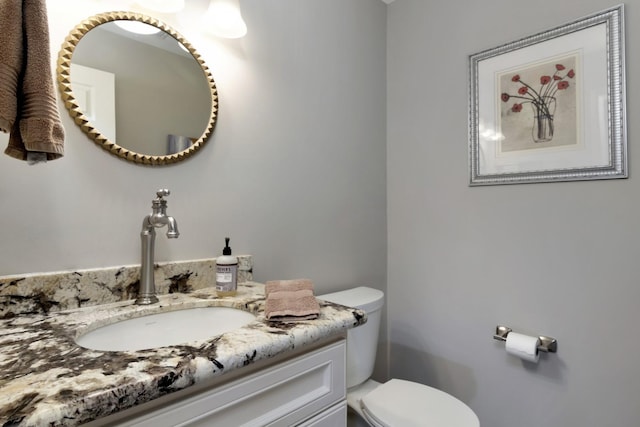 half bath with vanity and toilet