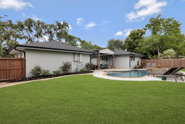 back of property with a fenced backyard, a fenced in pool, brick siding, a patio area, and a yard