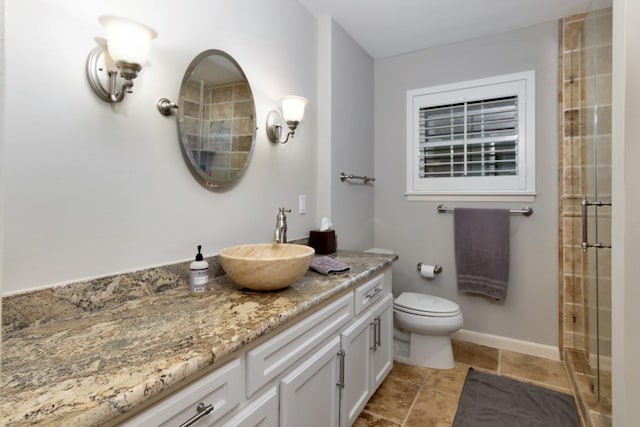 bathroom with vanity, tile patterned flooring, a tile shower, and toilet