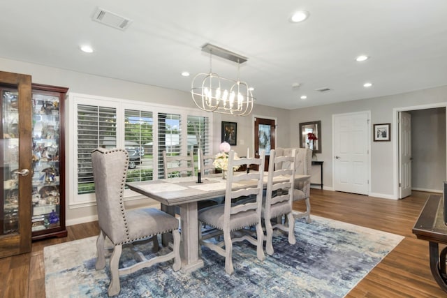 dining area featuring an inviting chandelier, recessed lighting, wood finished floors, and visible vents