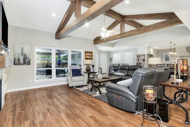 living area featuring vaulted ceiling with beams, a ceiling fan, recessed lighting, and a fireplace