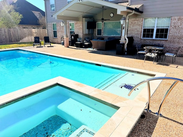 view of pool featuring a fenced in pool, fence, a patio, and an outdoor hangout area