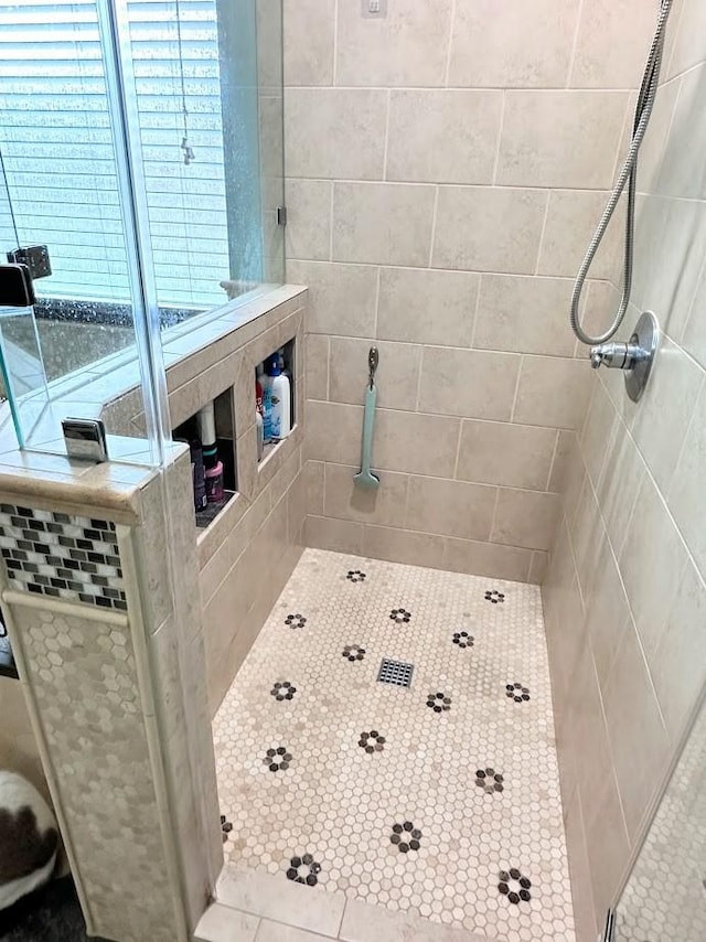 full bathroom with tiled shower