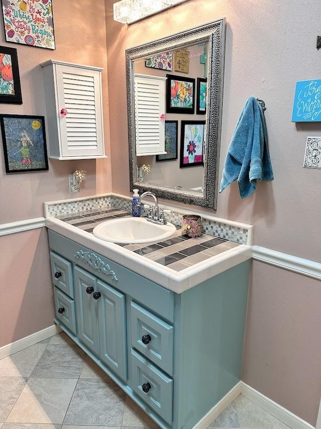 bathroom with vanity and baseboards