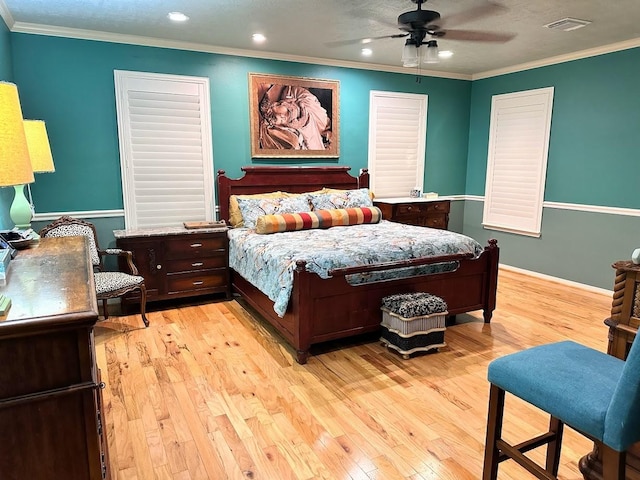 bedroom featuring light wood-style floors, ornamental molding, recessed lighting, and visible vents