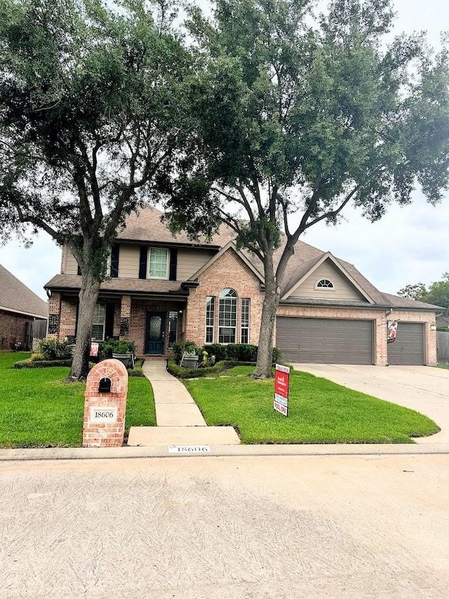 18606 Spring Heather Ct, Spring, TX 77379 - view of front facade with brick siding, a front yard, and concrete driveway