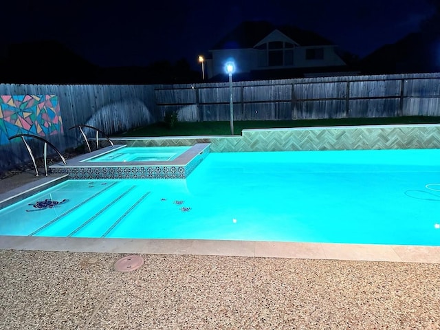 view of pool with a fenced backyard, a fenced in pool, and an in ground hot tub