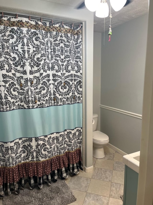 18606 Spring Heather Ct, Spring, TX 77379 - bathroom featuring vanity, toilet, baseboards, ceiling fan, and a shower with shower curtain
