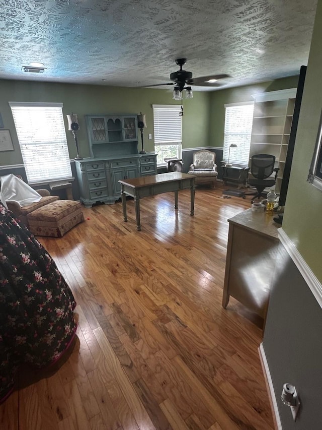 18606 Spring Heather Ct, Spring, TX 77379 - living area featuring wood-type flooring, a textured ceiling, and a ceiling fan