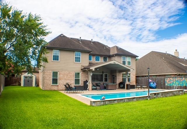 18606 Spring Heather Ct, Spring, TX 77379 - back of house with brick siding, an outdoor living space, and a patio