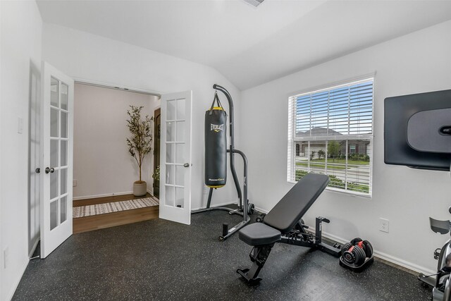 workout area with baseboards, french doors, and lofted ceiling