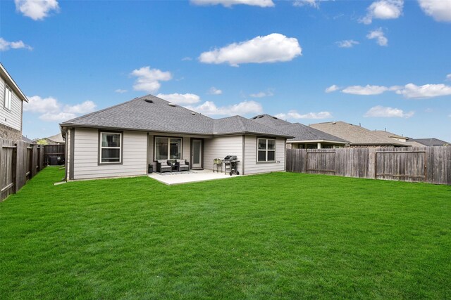 rear view of house featuring a fenced backyard, a shingled roof, a yard, and a patio area